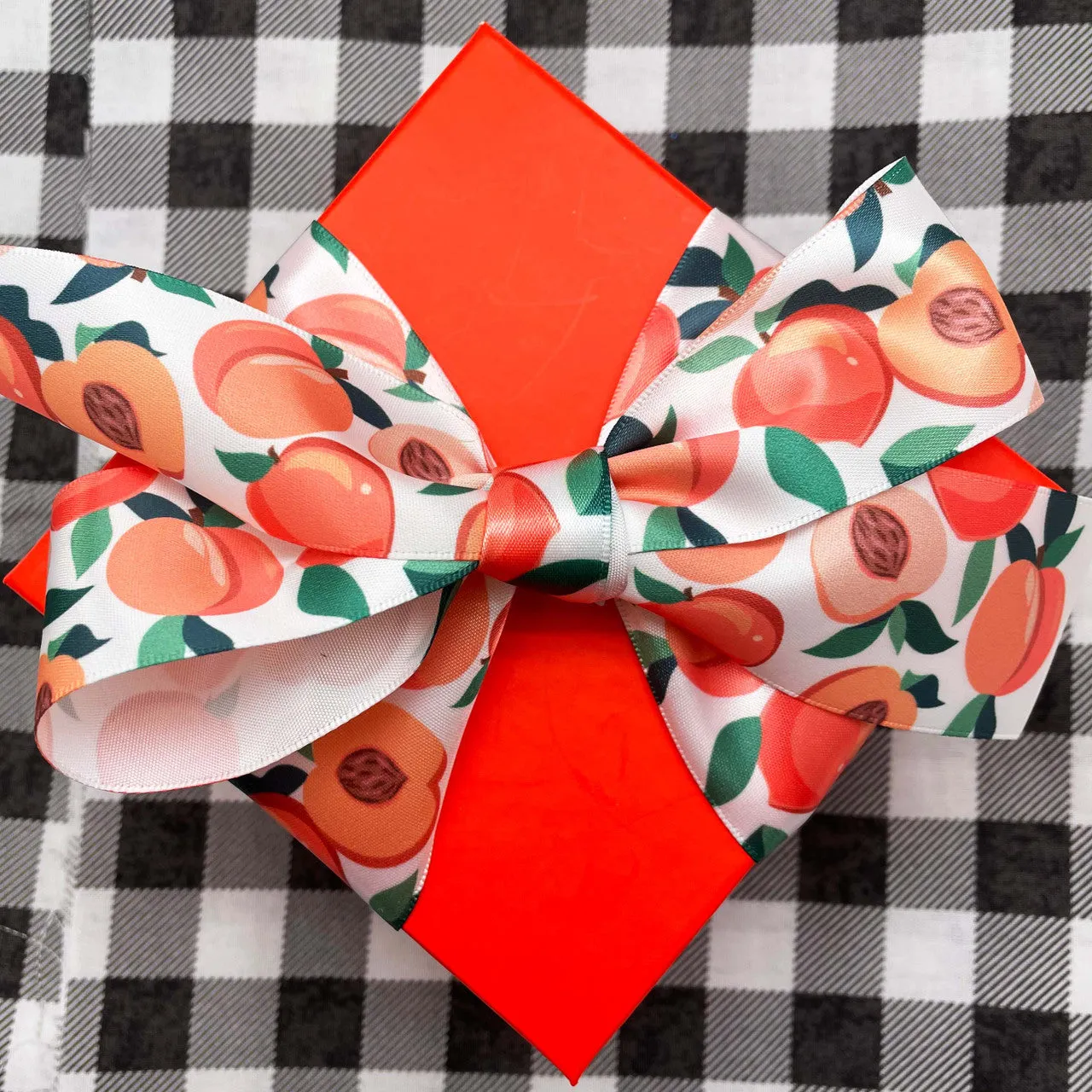 Peaches ribbon peach halves with pits and leaves printed on 1.5" white satin ribbon